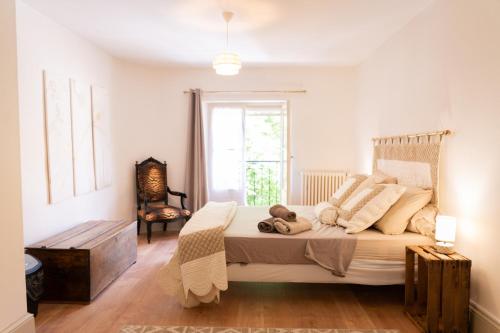 a bedroom with a large bed and a window at Chez ma poule in Moissac