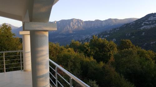a balcony of a house with a view of mountains at Yokana Villa & Pool in Virpazar