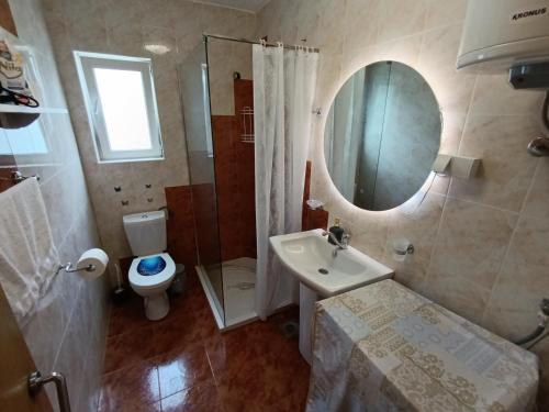 a bathroom with a sink and a toilet and a mirror at Green Valley GV in Kotor