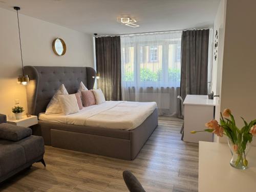 a bedroom with a bed and a living room at Prime Host Flair Apartment in Karlsruhe