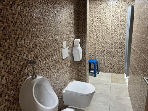 a bathroom with a urinal and a toilet in it at Casa do Adro in Viana do Castelo