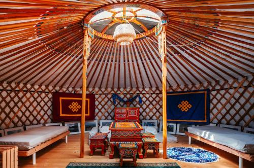 a yurt with two beds and a table in it at Jurtowisko in Wilcza Wólka