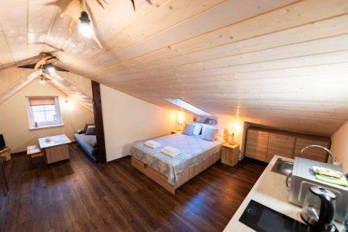 a bedroom with a bed in the middle of a attic at Šv Hubertas in Karklė