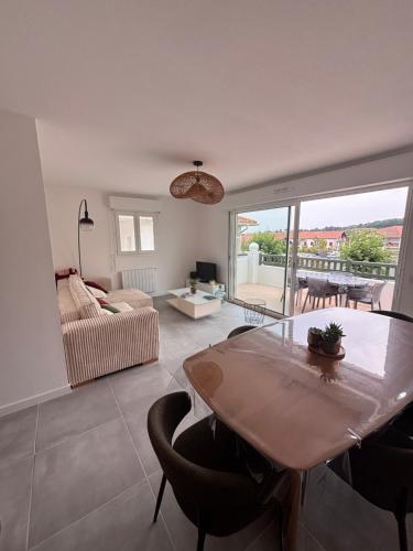 a living room with a table and a couch at Maison a Socoa in Urrugne