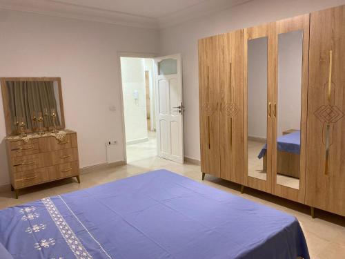 a bedroom with a bed and a dresser and a mirror at Dar Emna in Hammamet