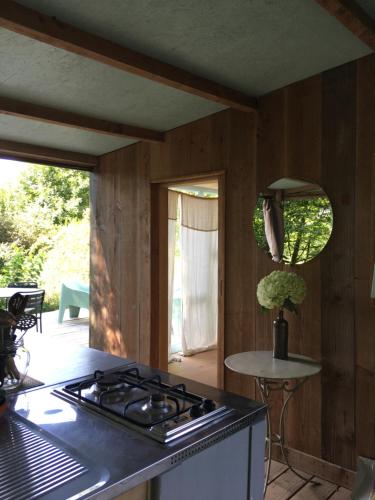 a kitchen with a stove and a counter top at Les Jardins d'Yzorche in Saint-Bazile-de-la-Roche