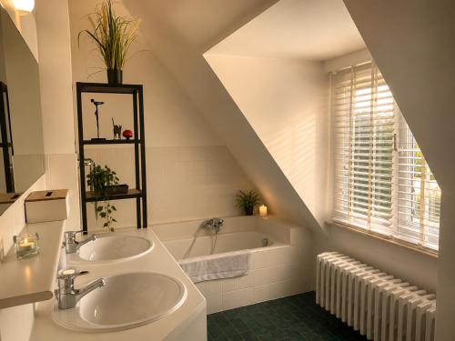a bathroom with a sink and a bath tub at Secret Garden in Waterloo