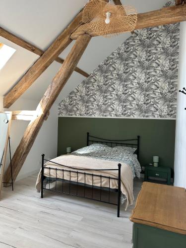 a bedroom with a bed in a attic at Le Petit Moineau in Arthon