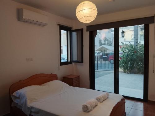 a bedroom with a bed and a large glass door at Millennium falcon in Larnaca