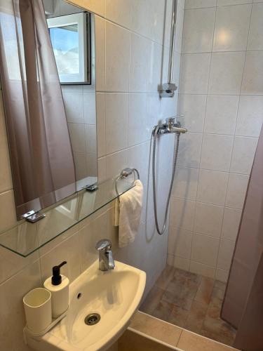 a bathroom with a sink and a shower at seafront HOUSE LALA Vinišće in Vinišće