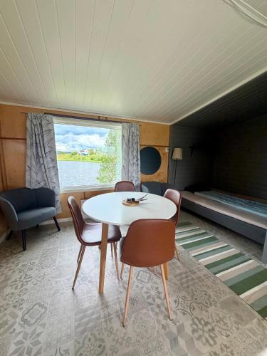 a dining room with a table and chairs and a bed at Arctic Motel and Kautokeino Camping in Kautokeino