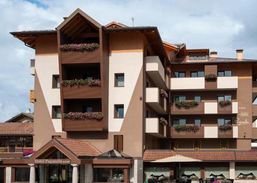 an apartment building with flower boxes on the balconies at Hotel Paganella Andalo in Andalo