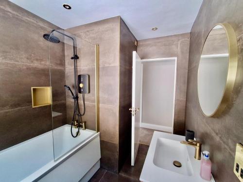 a bathroom with a sink and a mirror at The Waterfront House in Kinsale, hosted by Exquisite Holiday Homes in Dunderrow