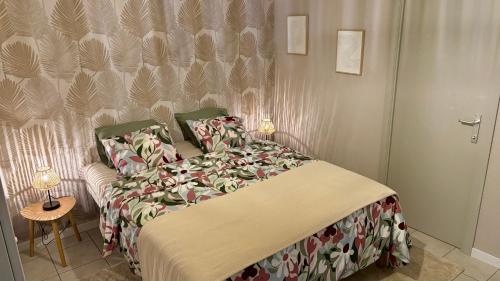 a bedroom with a bed and a table and a door at Au fil de la Semois in Bohan