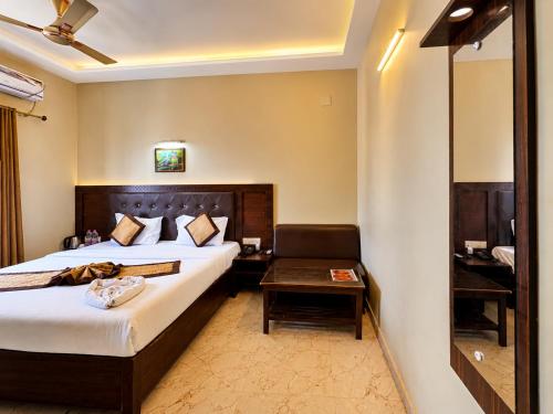 a hotel room with a bed and a chair at Hotel Puri Waves - Near Blue Flag Beach - Restautant, Parking & Spa in Puri