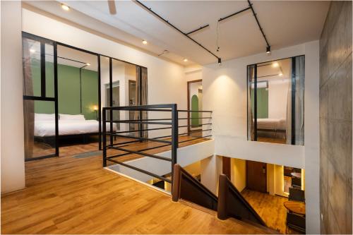 a loft apartment with a staircase and a bedroom at Sam's Apartment in Pātan