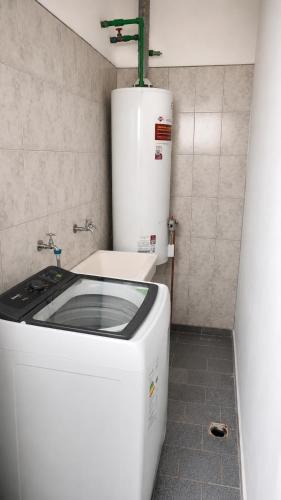 a small kitchen with a washer and a washer at JACARANDA - Alojamiento vacacional in Godoy Cruz