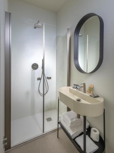 a bathroom with a sink and a shower at Hotel de La Ville - Self Check-In in Fidenza