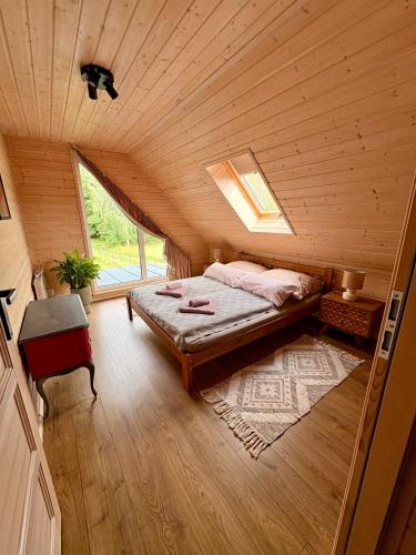 a bedroom with a bed in a wooden room at Mielno Woodhouse in Mielno