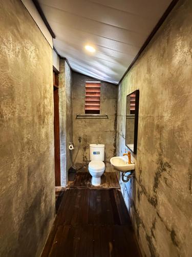 a bathroom with a toilet and a sink at Zen Tree House in Silebeng