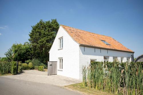 a white house with an orange roof at 't Boshuisje in Poperinge
