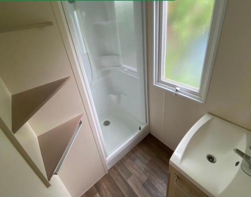 a bathroom with a shower and a sink at La Colline aux Chalets, Jaccuzi, Sauna in Saint-Chamarand
