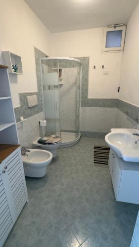 a bathroom with two sinks and a shower and two toilets at case vacanza hoya in Lacco Ameno