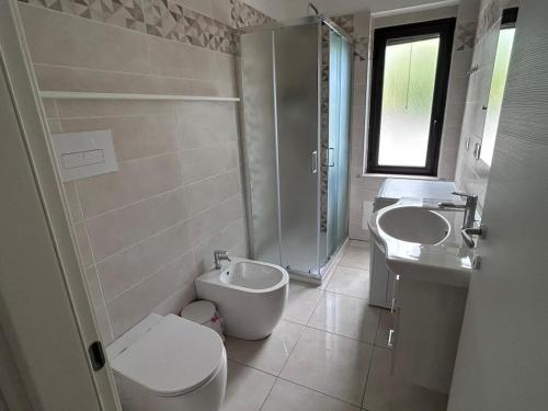 a bathroom with a toilet and a sink and a toilet at Villa del Limone in Sellia Marina