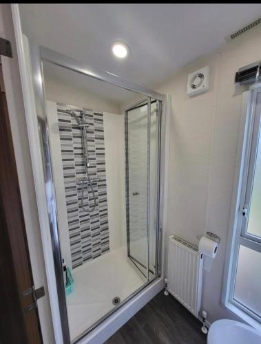 a shower in a bathroom with a glass shower stall at Craig Tara Beach Lodge in Ayr