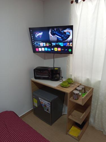 a room with a tv and a desk with a computer at Aparta estudio en Álamos in Pasto