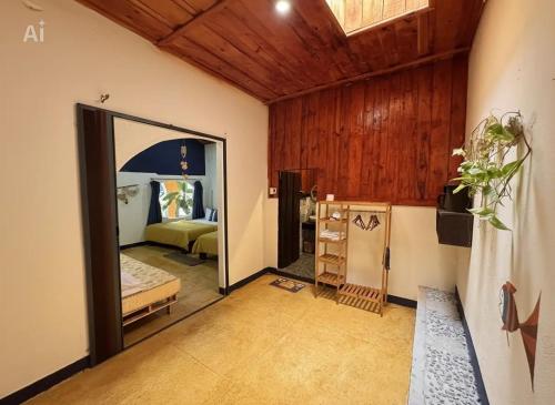 a room with a bedroom with a bed and a mirror at Family Room in Tam Kỳ