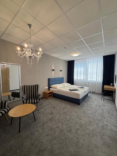 a bedroom with a bed and a table and chairs at City Hotel B&B, reception 24 7, 800m od-from R1, free parking in Banská Bystrica