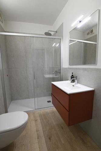 a bathroom with a shower and a sink and a toilet at Corte Nascimben in Marano di Valpolicella