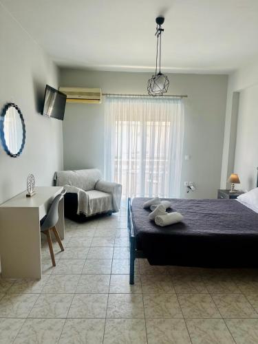 a bedroom with a bed and a living room at Armonia Apartments in Archangelos