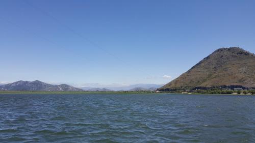 a view of the water with mountains in the background at Yokana Villa & Pool in Virpazar