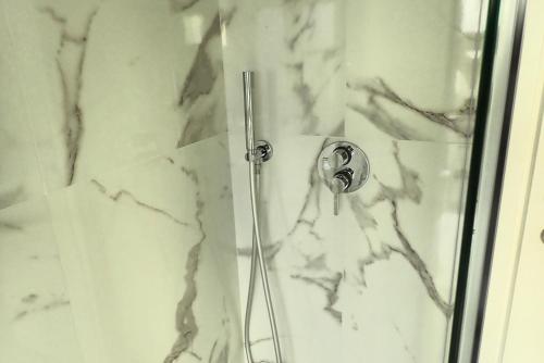 a shower with a glass door with a picture of a person at Moderno Bilocale Bresso in Bresso