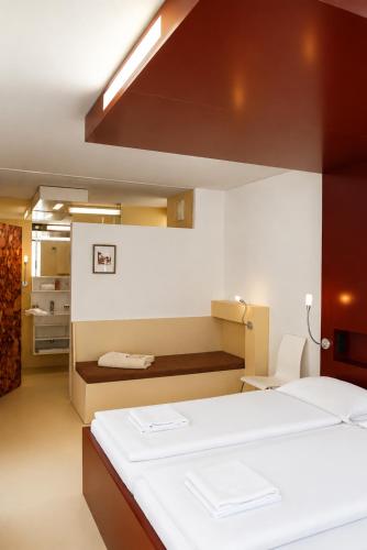 a bedroom with a large white bed in a room at Sun Matrei Apartments in Matrei in Osttirol