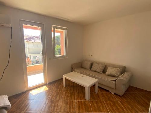 a living room with a couch and a table at Apartmani Adelisa in Šušanj