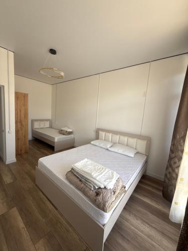 a bedroom with a large bed with white walls at Lake in Bosteri