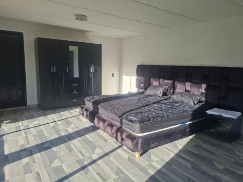 a bedroom with a large bed in a room at Alojamiento Campestre Barachel in Pamplona