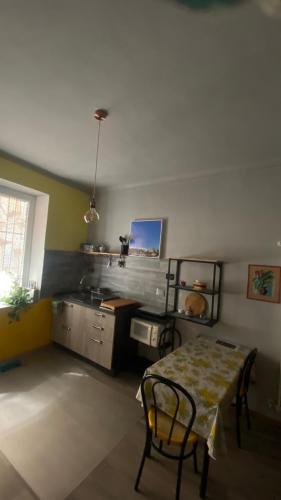 a kitchen with a table and a kitchen with a stove at Pinerolo medievale in Pinerolo
