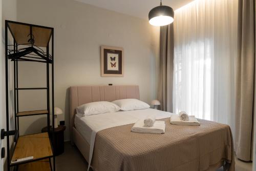 a bedroom with a bed with two towels on it at Annasa Suites 1 in Mángana