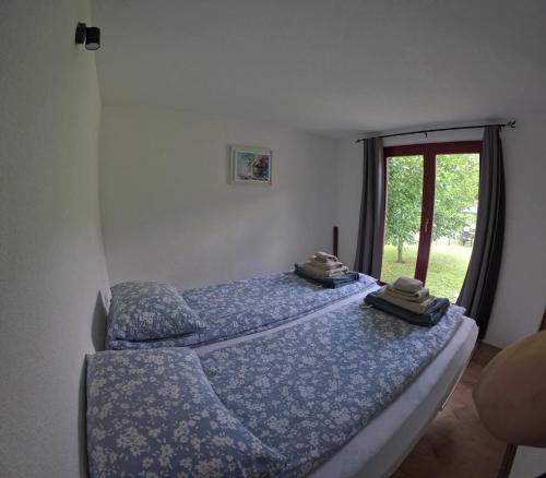 a bedroom with two beds and a window at Una Bliss in Kulen Vakuf