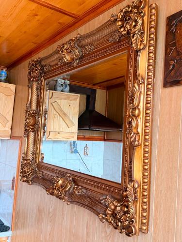 an ornate mirror on a wall in a kitchen at Mieszkanie Pod Sztolniami- Riese in Walim
