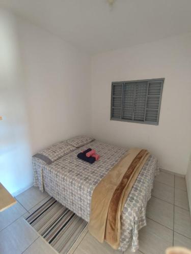 a bedroom with a bed in a white room at Recanto da Nonô in Gonçalves