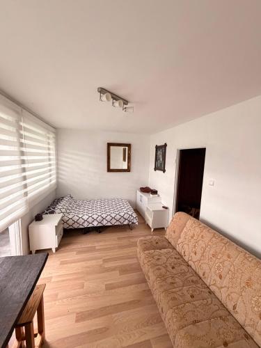 a living room with a couch and a bed at Mieszkanie Pod Sztolniami- Riese in Walim