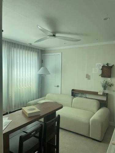 a living room with a couch and a table at Daejeon Motto stay in Daejeon