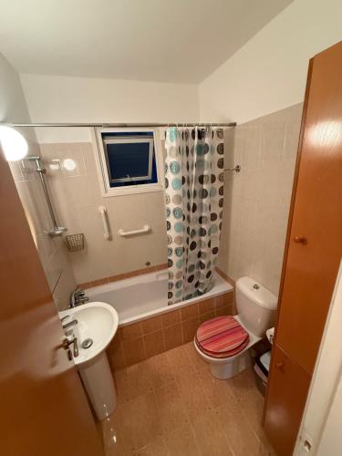 a bathroom with a sink and a toilet and a shower at Lux Family Suite & Pool in Larnaca
