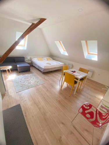a bedroom with a bed and a table and chairs at Apartmány Lednice in Lednice