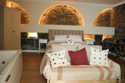 a bedroom with a bed with pillows on it at Aprosmeno House 5 in Agros